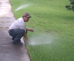 a tech is checking a sprinkler head