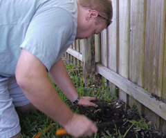 a sprinkler repair tech is checking a valve